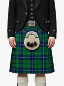 Person wearing a green and blue plaid kilt with a black jacket on a white background