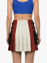 Person wearing a blue crop top and a red and white pleated skirt with black accents on a white background