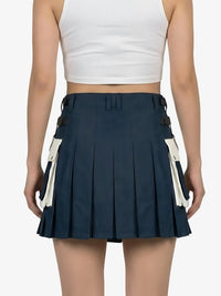 Navy pleated skirt with white accents worn by a person on a plain background