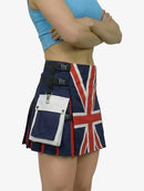 Person wearing a Union Jack skirt with a white bag on a plain background