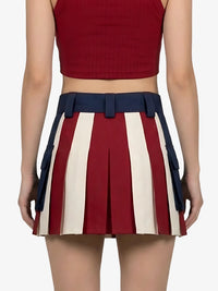 Person wearing a red top and a pleated skirt with red, white, and blue stripes on a white background