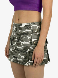 Person wearing a camouflage skirt with a purple top on a white background