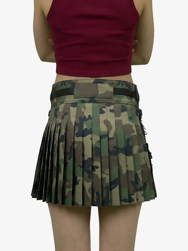 Person wearing a red top and camouflage pleated skirt on a white background